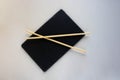 Asian cuisine is a Black Slate plate with chopsticks. An empty sushi plate on a white table Royalty Free Stock Photo