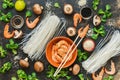 Asian cuisine. Ingredients for cooking on a rustic background. Rice noodles, shrimps, mushrooms.Vid from above.