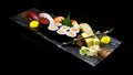 Asian cuisine or Japanese food. Sushi medium set on wooden plate Royalty Free Stock Photo