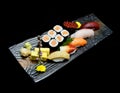 Asian cuisine or Japanese food. Sushi medium set on wooden plate Royalty Free Stock Photo