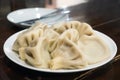 Asian cuisine. National Georgian food khinkali with Satsebeli sauce in a white plate. Tbilisi, Georgia