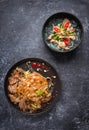 Asian Cuisine, Spicy Asian Beef Noodles and Pho bo on dark background