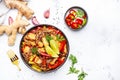 Asian cuisine, stir fry noodles with chicken and vegetables, red paprika and zucchini, sesame seed and soy sauce in bowl. White Royalty Free Stock Photo