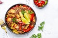 Asian cuisine, stir fry noodles with chicken and vegetables, red paprika and zucchini, sesame seed and soy sauce in bowl. White Royalty Free Stock Photo