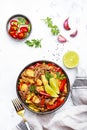 Asian cuisine, stir fry noodles with chicken and vegetables, red paprika and zucchini, sesame seed and soy sauce in bowl. White Royalty Free Stock Photo