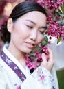 Asian culture concept. asian woman with closed eyes holding branches of the tree Royalty Free Stock Photo