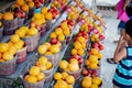 Asian customer sampling fresh picked oranges, peaches, mangos at roadside market stand in Santa Rosa, Destin, Florid, homegrown Royalty Free Stock Photo