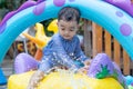 Asian cute baby boy playing in inflatable baby pool Royalty Free Stock Photo