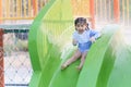 Asian cute baby girl daughter laughing happy and swimming playing slide pool in the pool at the resort, smiling and laughing. Royalty Free Stock Photo