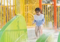 Asian cute baby girl daughter laughing happy and swimming playing slide pool in the pool at the resort, smiling and laughing. Royalty Free Stock Photo