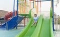 Asian cute baby girl daughter laughing happy and swimming playing slide pool in the pool at the resort, smiling and laughing. Royalty Free Stock Photo