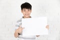 Asian cute boy holding blank white board . Royalty Free Stock Photo