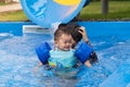 Asian cute boy and mother happiness in swimming pool