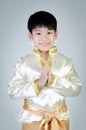 Asian cute boy in thai costume acting Hello