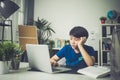 Asian cute boy using laptop computer. Royalty Free Stock Photo