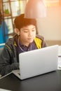 Asian cute boy using laptop computer. Royalty Free Stock Photo