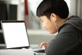 Asian cute boy using laptop computer. Royalty Free Stock Photo