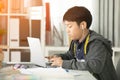 Asian cute boy using laptop computer. Royalty Free Stock Photo