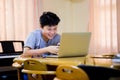 Asian cute boy using laptop computer to learning at home Royalty Free Stock Photo