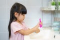 Asian cute child girl or kid Squeeze the toothpaste into toothbrush before brushing her teeth in the bathroom. Dental hygiene Royalty Free Stock Photo