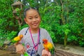 Asian cute child girl with Sun Conure parrot