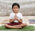 Asian Cute Girl Doing Breathing Exercise. Cute girl at home in lotus position Royalty Free Stock Photo