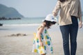 Asian cute girl and her mother walking or running or playing on the beach on summer holidays. Children with beautiful sea, sand Royalty Free Stock Photo