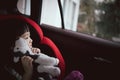 Asian cute girl play puppy doll in car seat. Royalty Free Stock Photo