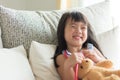 Asian cute little girl is smiling and playing doctor with stethoscope. Kid and health care concept.