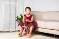 Asian cute little girl swinging riding toy horse Royalty Free Stock Photo