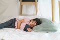 Asian cute little girl watching cartoon in smartphone while lying in a blanket fort in living room at home for perfect hideout Royalty Free Stock Photo