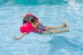 Asian cute little kid girl swimming in a pool Royalty Free Stock Photo