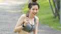 Asian cute sport healthy fit and firm slim teen girl eat ice cream in summer day at outdoor garden park