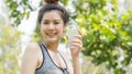 Asian cute sport healthy fit and firm slim teen lady hold plastic bottle of water on the hand in summer hot day at outdoor garden