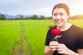 Asian cute teen girl plus size with red heart love green nature background Royalty Free Stock Photo