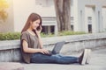 Asian Cute teen women calling with smartphone and using laptop computer happiness and smile enjoy in campus Royalty Free Stock Photo