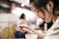 Asian cute woman drinking chocolate frappe in cafe shop