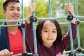 Asian dad and daughter on playground Royalty Free Stock Photo