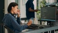 Asian database programer writing code on computer