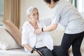 Asian daughter in charge is helping to dress up,chang clothes for a helpless old patient,taking care of senior mother suffer from Royalty Free Stock Photo