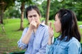 Asian daughter child girl checking breath with her hand,teenager girl horrible bad breath,foul mouth,mother closing her nose,very