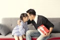 Asian daughter give present for father. concept surprise gift box for birthday