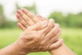 Asian daughter greeting or pay respect to her mother, two hands holding each others Royalty Free Stock Photo