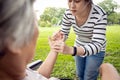 Asian daughter massaging palm and fingers of senior mother,elderly people having heumatoid arthritis, beriberi,peripheral