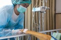 Asian daughter in protective clothing,wear medical face mask and gloves,woman holding hands,visit her mother who was suffering Royalty Free Stock Photo