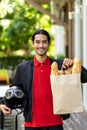 Asian deliverly man hold grocery bag