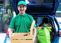 Asian delivery man in green t-shirt delivering food