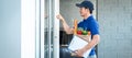 Asian delivery man holding grocery bag of food, fruit, vegetable and  invoice clipboard during knocking Royalty Free Stock Photo