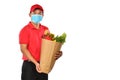 Asian delivery man in red uniform, medical face mask carry grocery bag in hands isolated on white background