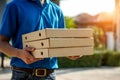 Asian delivery man wearing mask delivers pizza